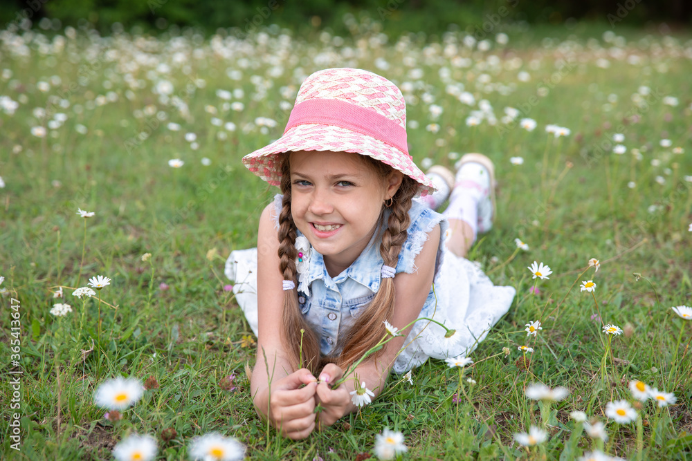 Lovely joyful little blond girl in a beautiful hat Lovely joyful little blond girl in a beautiful hat