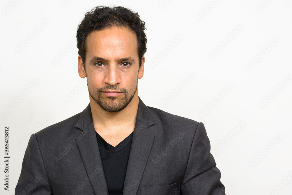 Portrait of handsome bearded Hispanic businessman in suit Portrait of handsome bearded Hispanic businessman in suit