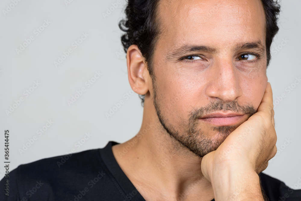 Portrait of handsome bearded Hispanic man with curly hair Portrait of handsome bearded Hispanic man with curly hair