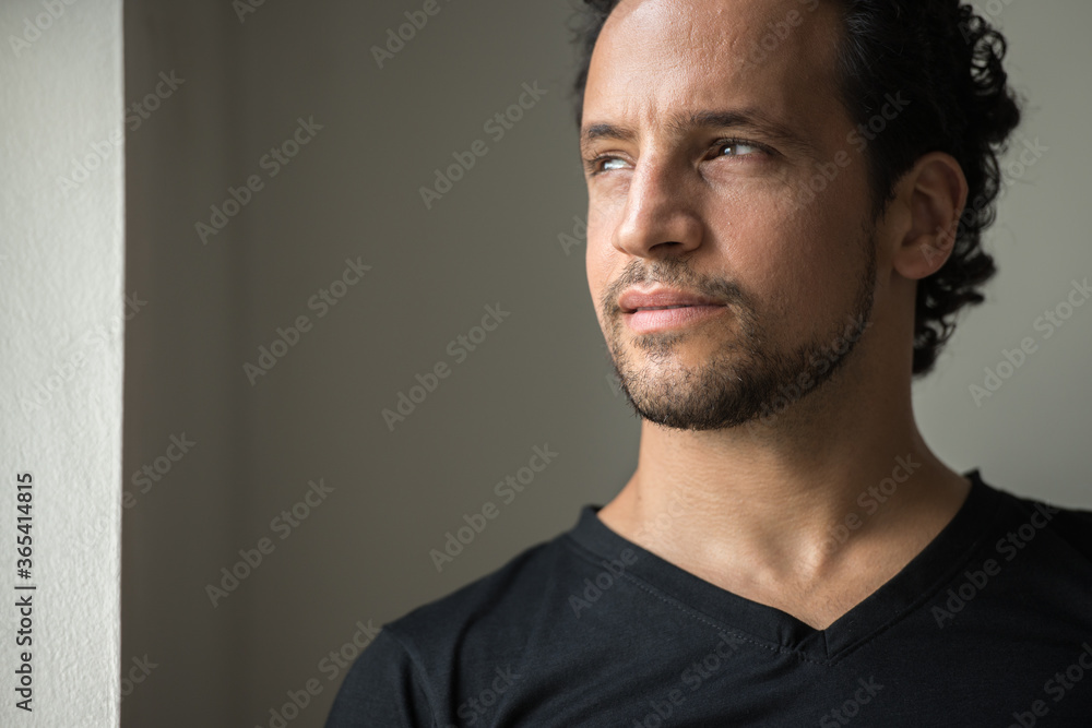 Fototapeta premium Portrait of handsome bearded Hispanic man indoors