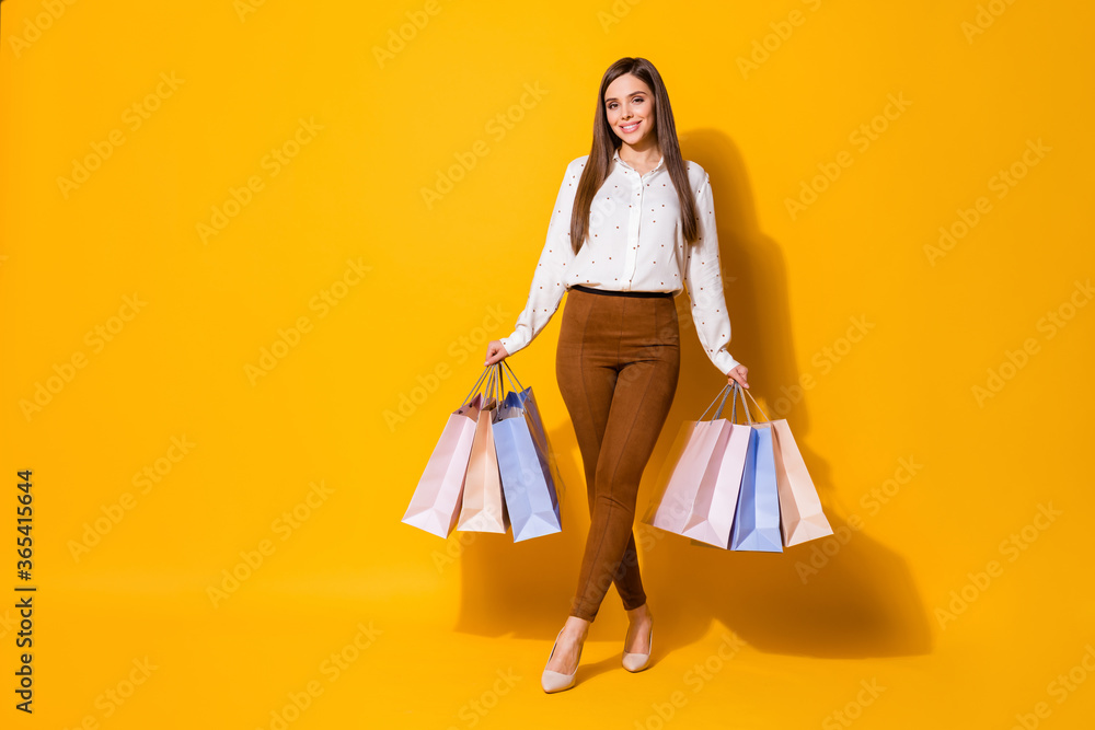 Full length photo of positive cheerful girl shopaholic have free time hold bags buy presents gifts wear good look blouse stilettos isolated over bright color background Full length photo of positive cheerful girl shopaholic have free time hold bags buy presents gifts wear good look blouse stilettos isolated over bright color background