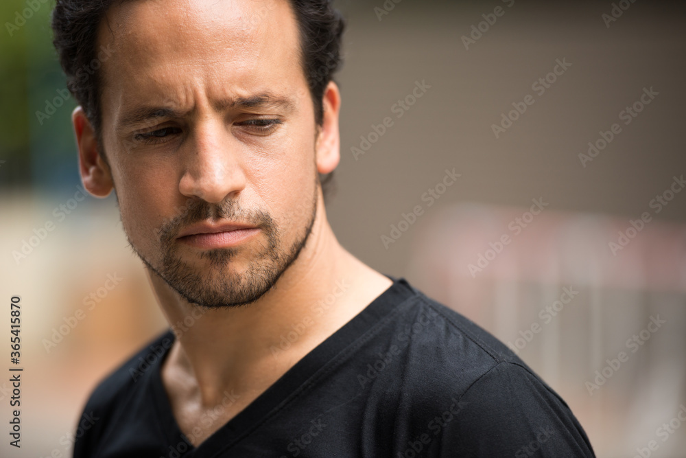 Fototapeta premium Handsome bearded Hispanic man in the streets outdoors