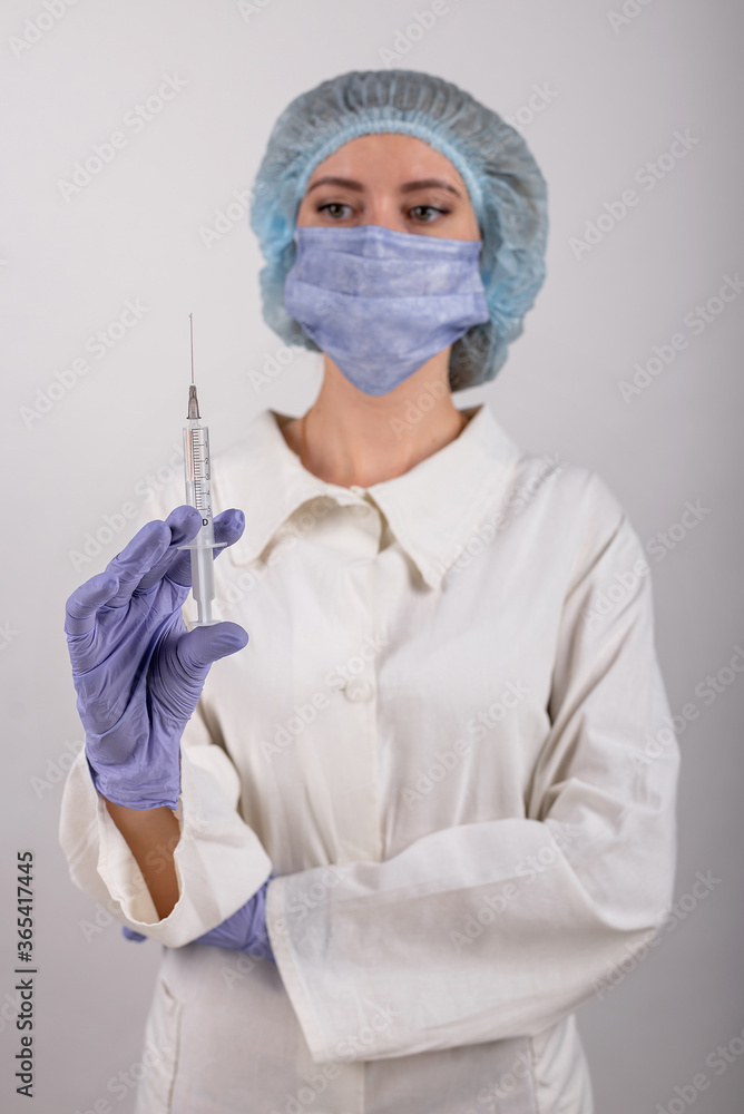 medical worker in blue gloves holds a syringe with a vaccine medical worker in blue gloves holds a syringe with a vaccine