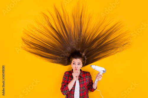 Top view above high angle flat lay flatlay lie concept of her she nice pretty curious cheery long-haired girl using hot warm air drier isolated on bright vivid shine vibrant yellow color background