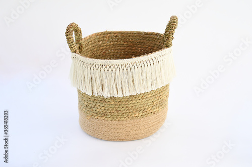 Object, beautiful empty nature straw basket with handle for easy carrying on white background. Object idea for containe many things as laundry, trash, or pot of tree .Decorate in home. photo