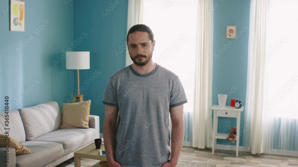 Young serious man is looking at camera, confident and decisive, brunette with dark eyes, in casual outfit, Caucasian, white, Slow motion. Young serious man is looking at camera, confident and decisive, brunette with dark eyes, in casual outfit, Caucasian, white, Slow motion.