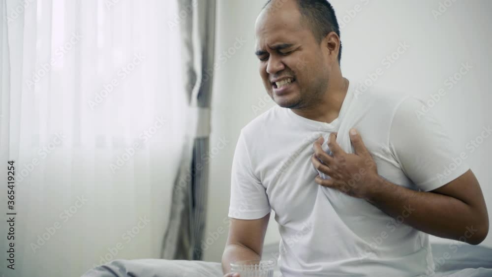 asian-sick-person-has-pain-in-chest-while-he-drink-water-he-has