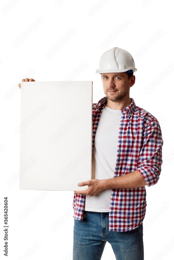 handyman worker in hard hat holding empty blank board. builder in shirt looking at the camera isolated on white studio background handyman worker in hard hat holding empty blank board. builder in shirt looking at the camera isolated on white studio background