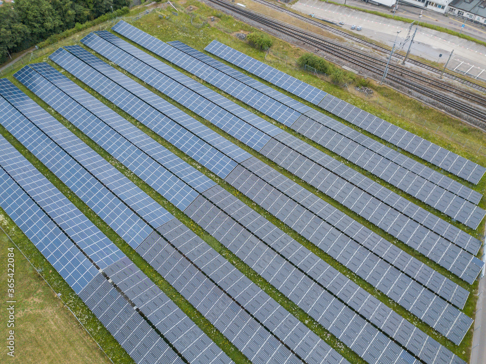 Aerial view of solar panels for photovoltaic power generation on field.