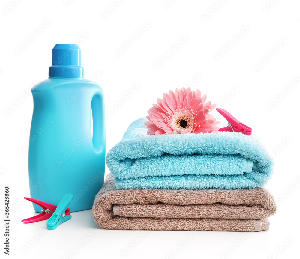 Detergent with washing powder and towels isolated on white Detergent with washing powder and towels isolated on white