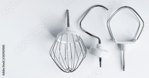 Quadro em tela attachments for a planetary mixer, for whipping cream and kneading dough, on a white background concept of kitchen appliances