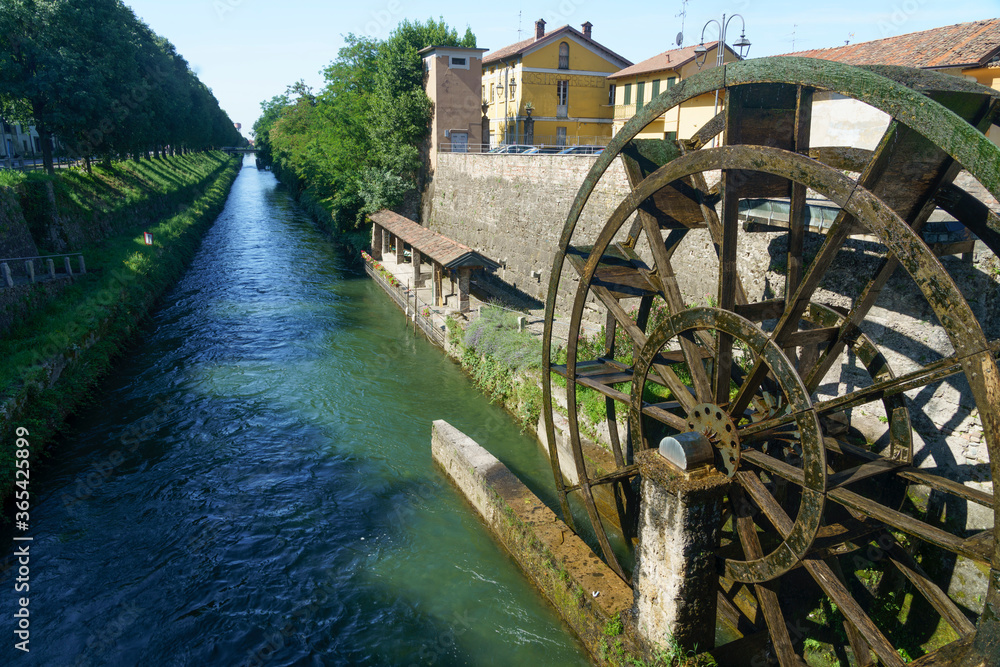 Groppello (Italy): big wooden wheel on Martesana canal Groppello (Italy): big wooden wheel on Martesana canal