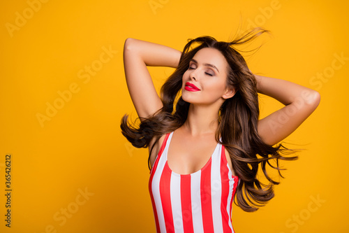 Photo of lovely beauty lady hairdo flight breeze blow relaxing arms behind head eyes closed sun bathing seaside wear white red striped bodysuit isolated bright yellow color background
