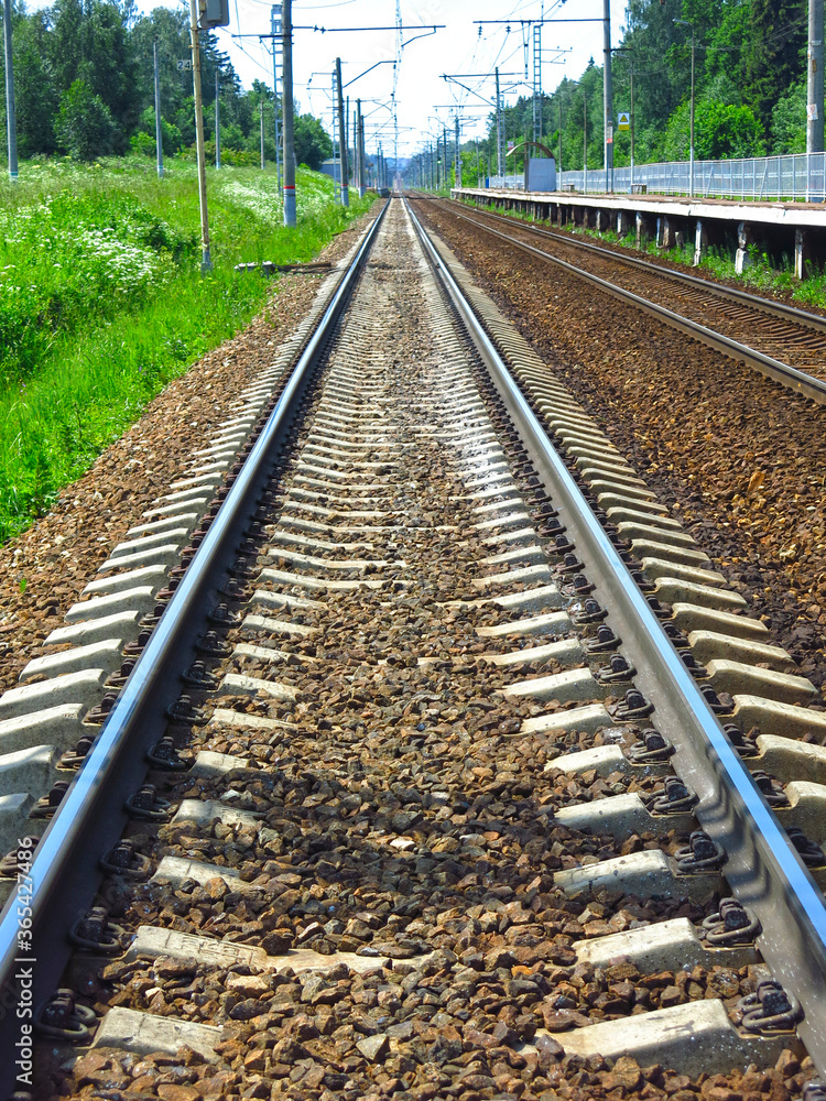 rails of the railway track in summer in Sunny weather stretch into the distance rails of the railway track in summer in Sunny weather stretch into the distance