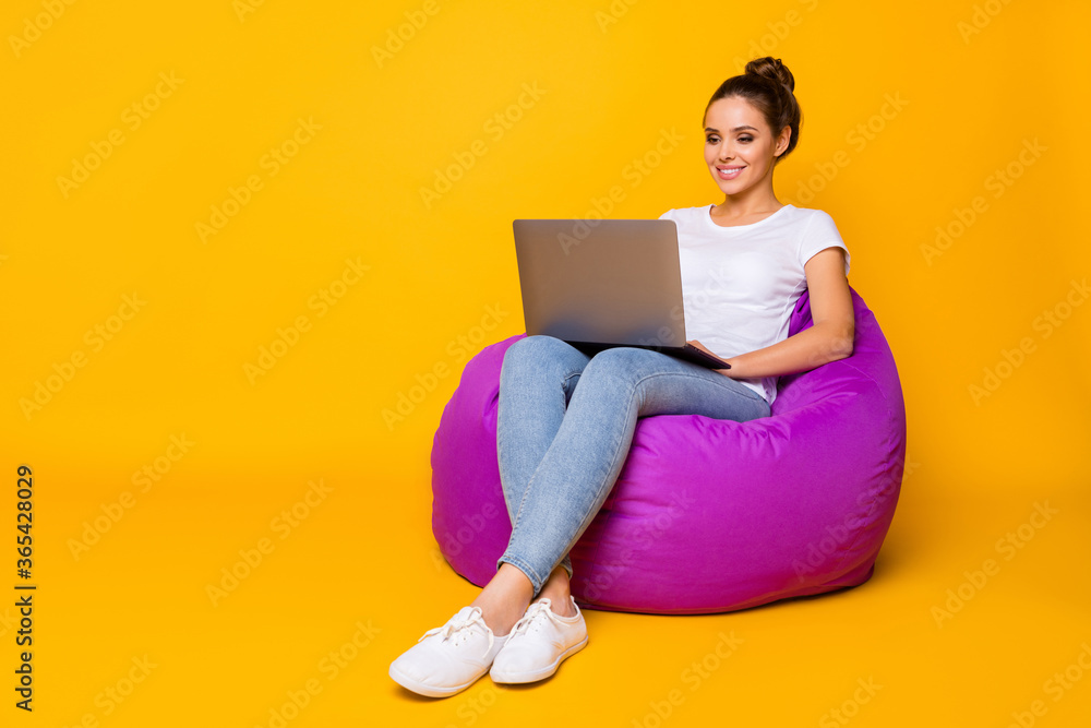 Naklejka premium Full body photo of positive cheerful girl sit violet bag armchair use computer read e-book wear white t-shirt footwear isolated over bright shine color background