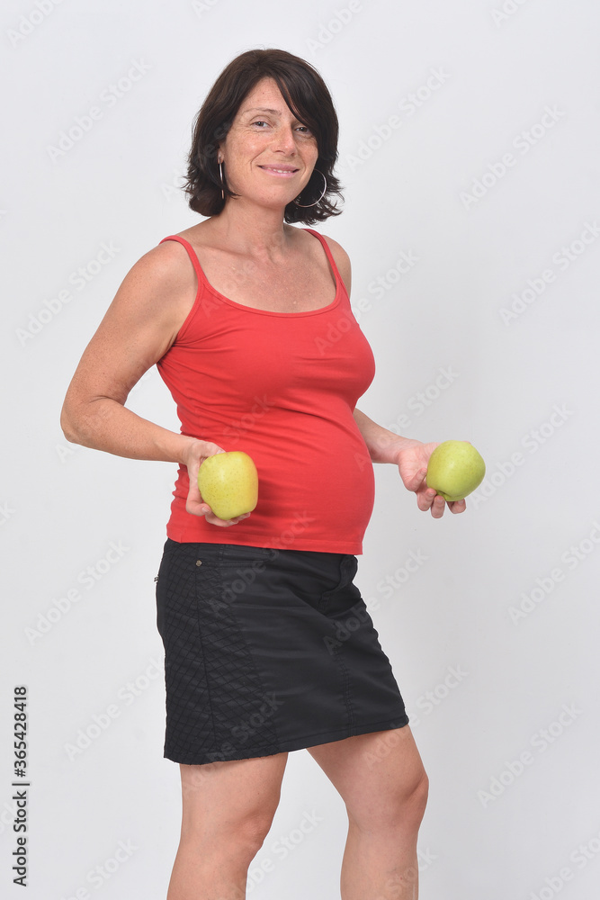 pregnant woman holding a apple on white background pregnant woman holding a apple on white background
