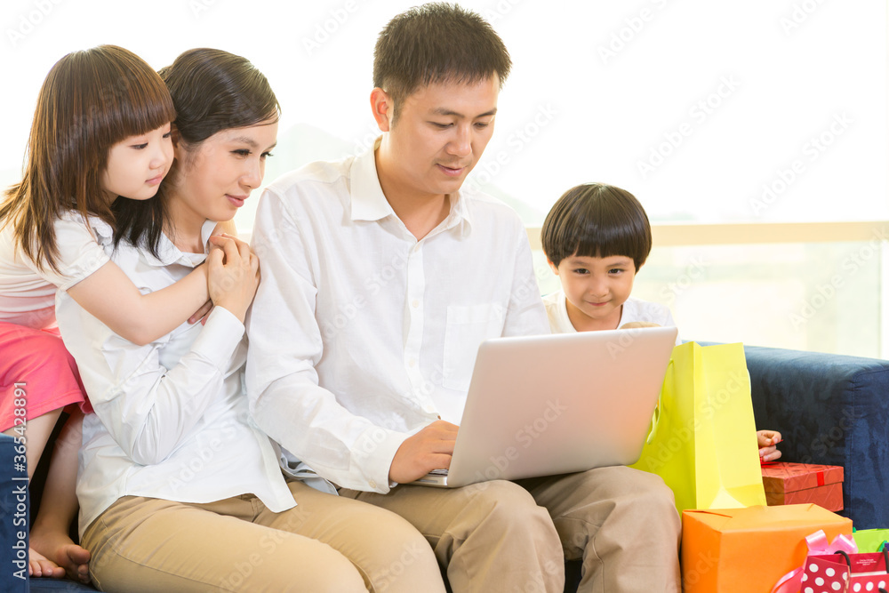 Happy family using laptop on festival day Happy family using laptop on festival day