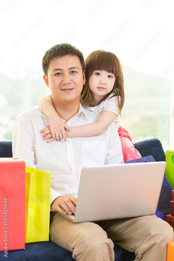 Father and daughter using laptop together at home Father and daughter using laptop together at home