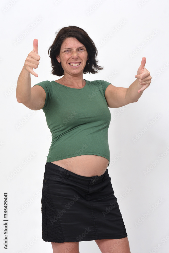 portrait of a pregnant woman with horned sign on white background portrait of a pregnant woman with horned sign on white background