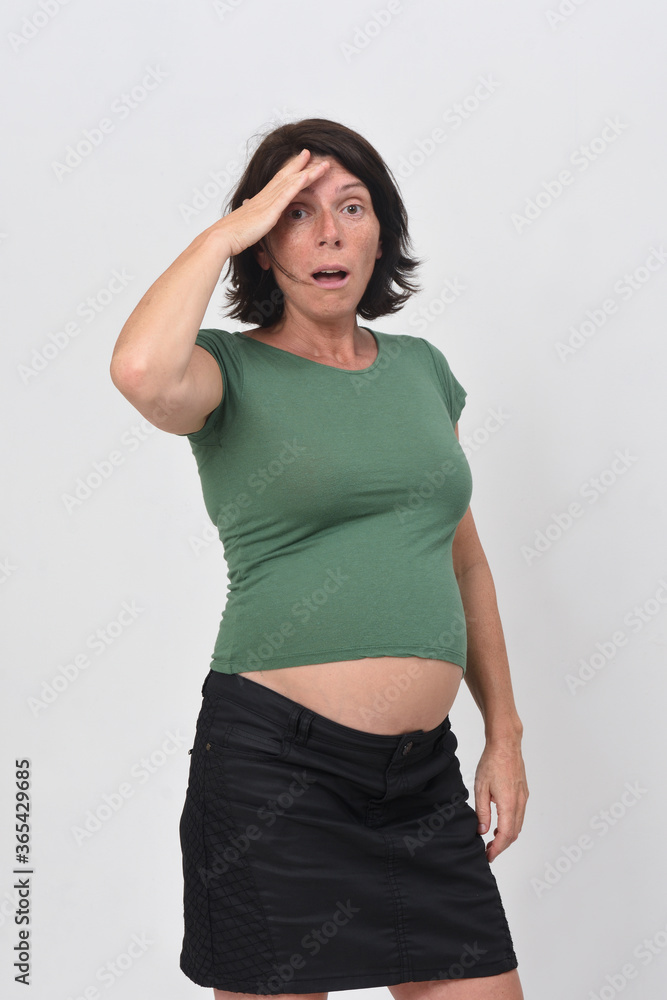 pregnant woman with expression of forgetting on white background pregnant woman with expression of forgetting on white background
