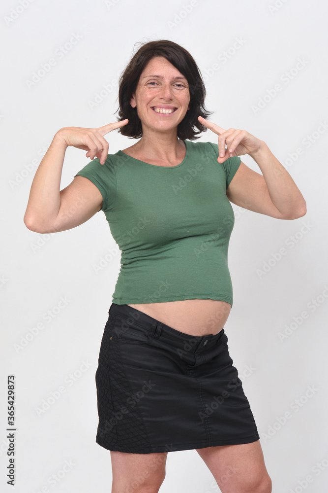 pregnant woman pointing her smile on white background pregnant woman pointing her smile on white background