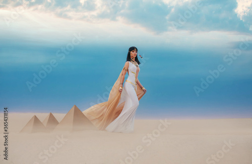 Photos young beautiful woman model image Queen Cleopatra walks in desert Egyptian pyramids