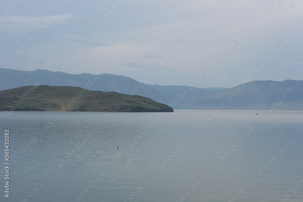 Baikal Lake. View of the shore of Olkhon Island and the coastal forest on the beach. Beautiful view of the sandy beach and lake Baikal. Photo with Copy space Baikal Lake. View of the shore of Olkhon Island and the coastal forest on the beach. Beautiful view of the sandy beach and lake Baikal. Photo with Copy space