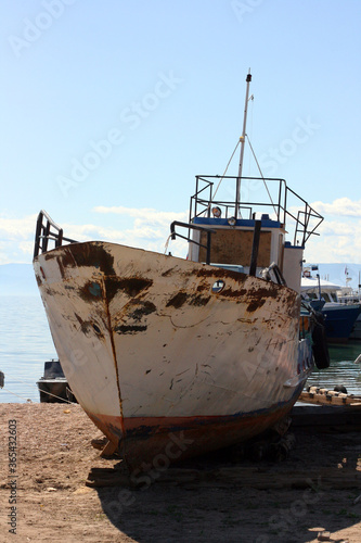Olkhon / Russia - June 27, 2019: Excursion boats on the shore of the Baikal lake. Lake Baikal. The deepest lake on the planet. Fresh reservoir. 