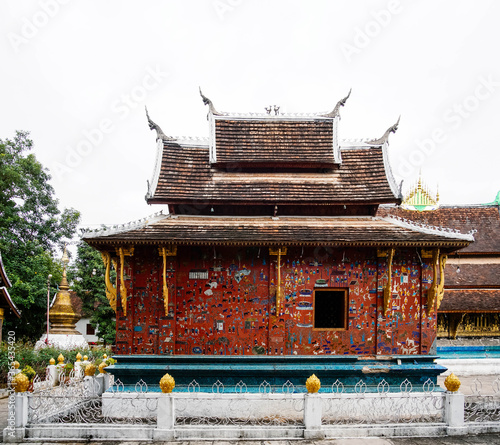 Art​ on​ temple wall colourful glass tiles picture decoration at Wat Xieng thong temple,Luang Pra bang, Laos photo