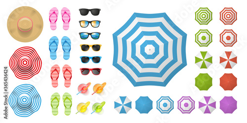 Beach elements and objects. (top view) Hats, flip-flops, sunglasses, cocktails, sun umbrellas. (view from above).