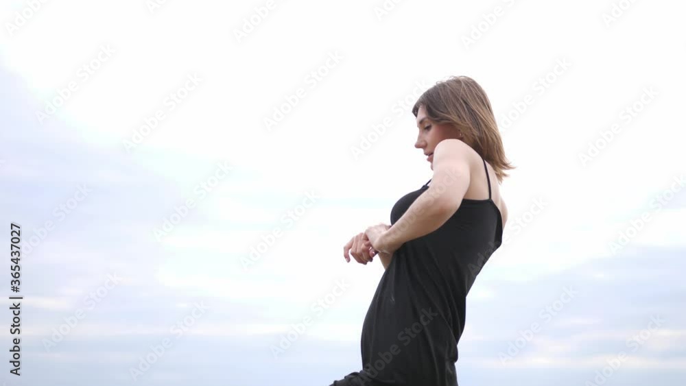 Young beautiful woman dancing on the seashore. slow motion Young beautiful woman dancing on the seashore. slow motion
