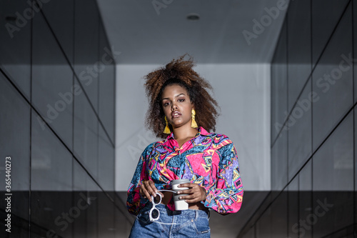 Photography Stylish black woman with coffee to go