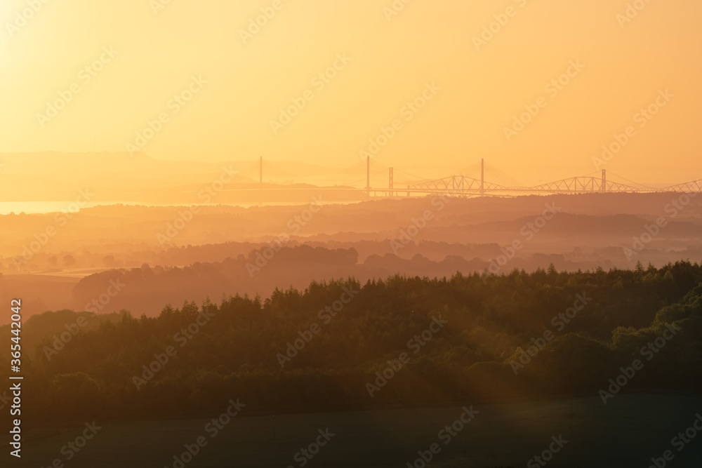 Three bridges opposite the rising sun and the sea. Forth Brtidges and Queensferry Crossing, Scotland, United Kingdom Three bridges opposite the rising sun and the sea. Forth Brtidges and Queensferry Crossing, Scotland, United Kingdom