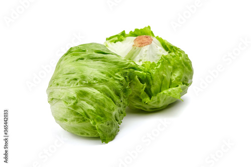 Iceberg lettuce isolated on white background. Two whole heads of crisphead lettuce, leafy green vegetables