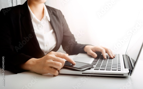 Digital marketing media in virtual screen.businesswoman hand working with mobile phone and modern compute with VR icon diagram at office in morning light