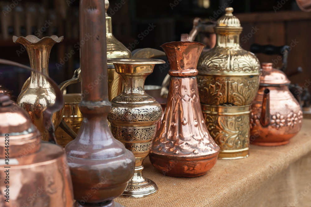 Assortment of stylized Oriental copper dishware Assortment of stylized Oriental copper dishware