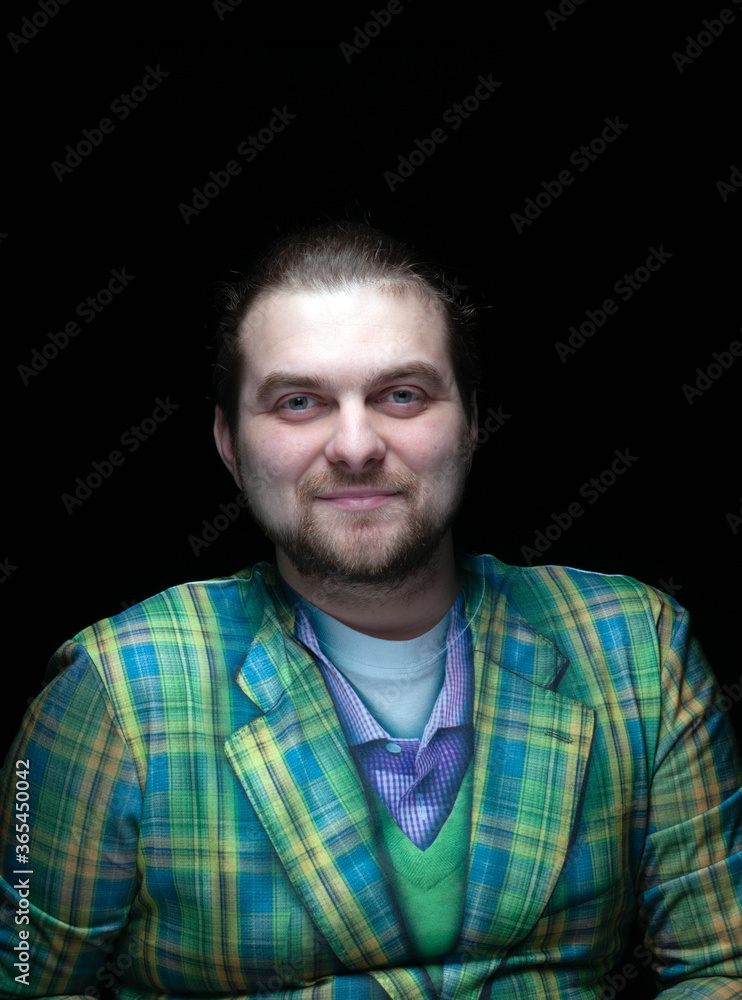 Fototapeta premium handsome positive stylish bearded man in green checkered blazer looking at camera isolated on black