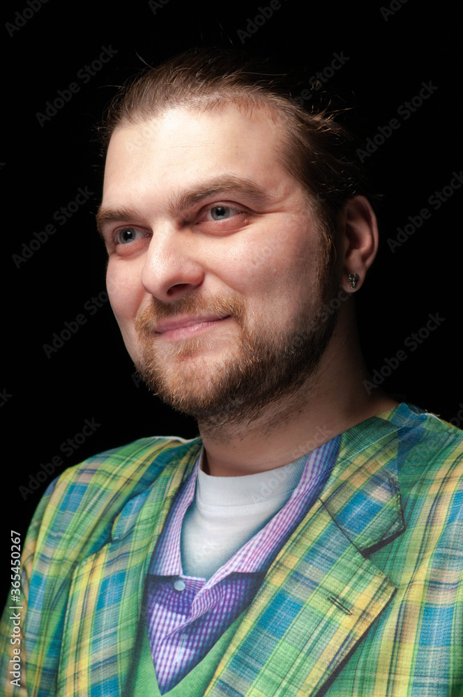 Obraz premium portrait of smiling cheerful stylish bearded man in green checkered blazer looking away isolated on black