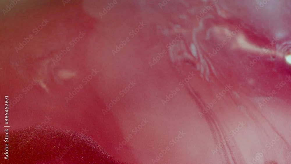 Abstract liquid pink background. Surface with a moving flow of paint, creative drops of color