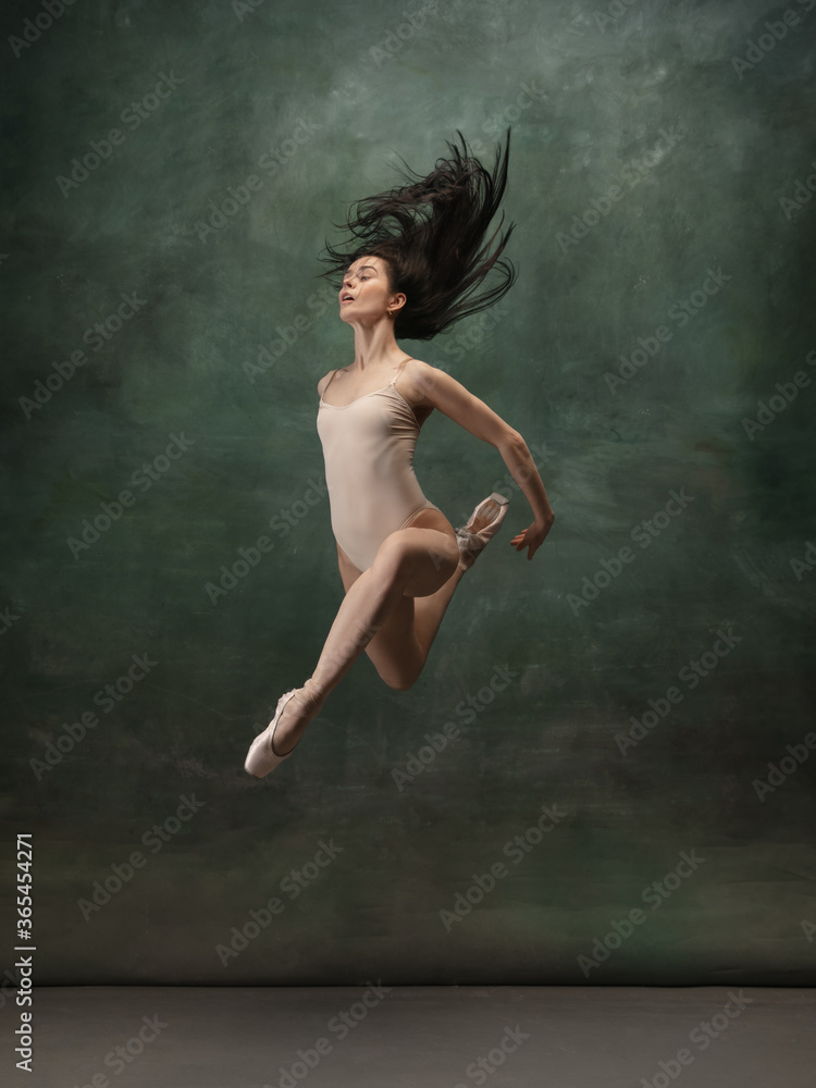 Target, achievement. Graceful classic ballerina dancing on dark studio background. Pastel bodysuit. The grace, artist, movement, action and motion concept. Looks weightless, flexible. Fashion, style. Target, achievement. Graceful classic ballerina dancing on dark studio background. Pastel bodysuit. The grace, artist, movement, action and motion concept. Looks weightless, flexible. Fashion, style.