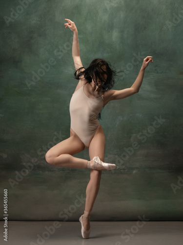 Inspiration. Graceful classic ballerina dancing on dark studio background. Pastel bodysuit. The grace, artist, movement, action and motion concept. Looks weightless, flexible. Fashion, style. © master1305