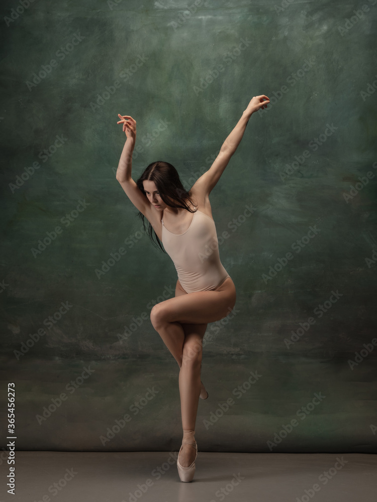 Artwork. Graceful classic ballerina dancing on dark studio background. Pastel bodysuit. The grace, artist, movement, action and motion concept. Looks weightless, flexible. Fashion, style.