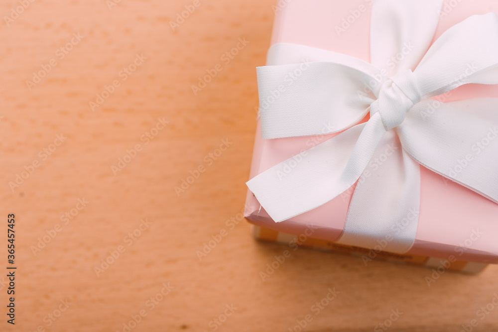 Beautiful gift box with altas bow on a vintage wooden board. holiday card concept. Beautiful gift box with altas bow on a vintage wooden board. holiday card concept.