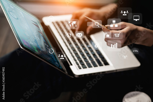 Business hand using laptop with social media marketing icon for internet network technology and business concept.