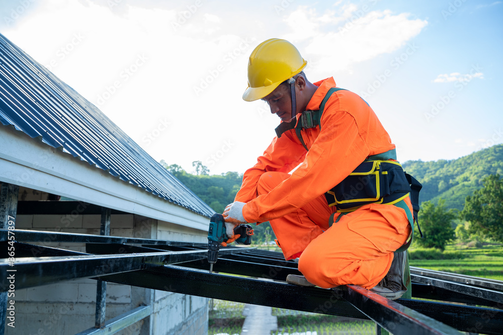 Professional technical workers working install new roof,Roofing tools,Electric drill used on new roofs with Metal Sheet. Professional technical workers working install new roof,Roofing tools,Electric drill used on new roofs with Metal Sheet.