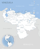 Blue-gray detailed map of Venezuela administrative divisions and location on the globe.