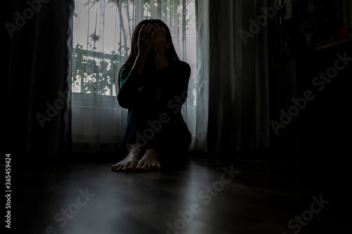 Sad young woman sitting on the bed in the bedroom, People with depression concept. 