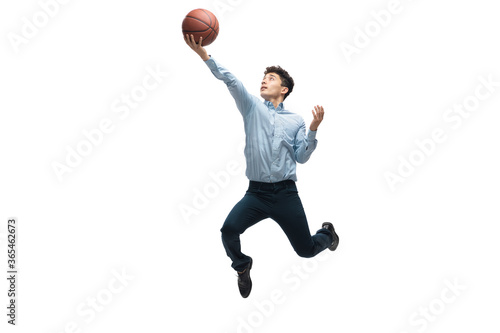 In jump. Man in office clothes playing basketball on white background like professional player, sportsman. Unusual look for businessman in motion, action with ball. Sport, healthy lifestyle © master1305