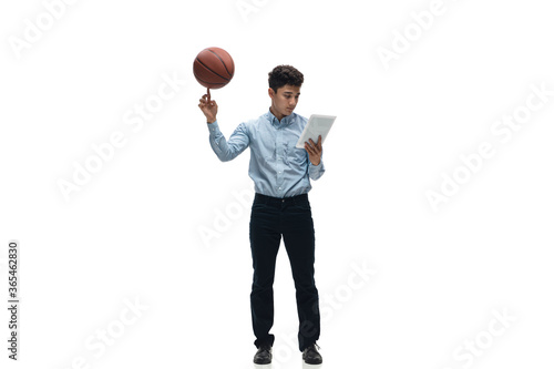 Busy. Man in office clothes playing basketball on white background like professional player, sportsman. Unusual look for businessman in motion, action with ball. Sport, healthy lifestyle, creativity.