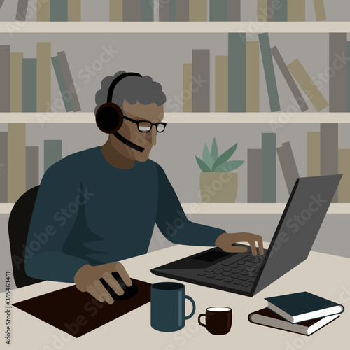 Older person in headphones with a microphone is working on a laptop. There are mugs and books on the table. Drawing in a flat style.
